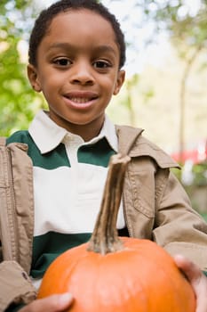 Boy holding a pumpkin