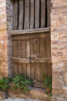 Ancient wooden door in an old Italian town. (Spello, Umbria, Italy)
