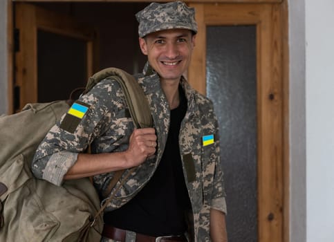 Ukrainian soldier wearing military uniform with flag and chevron depicting trident - Ukrainian national symbol flag.