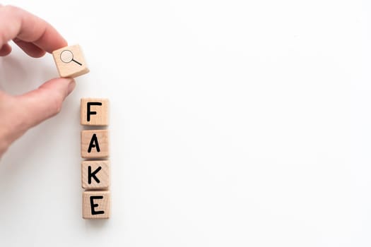 Fake news symbol. Wooden blocks with concept words Fake news on beautiful background from dollar bills. Business media and fake news concept. Copy space. High quality photo