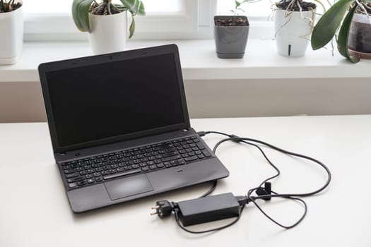 Person working on a laptop in a business office environment. High quality photo