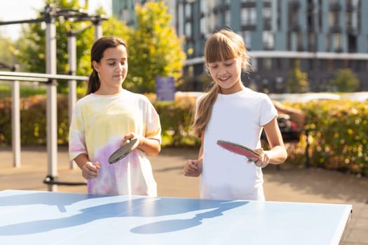 Photography of table tennis area in the public park. Street ping-pong sports competitions in spring day. Lifestyles of big city. People playing taBle tennis actively. High quality photo