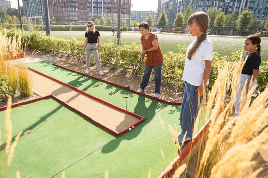 Kids playing golf inside playground artificial grass activity game for children . High quality photo