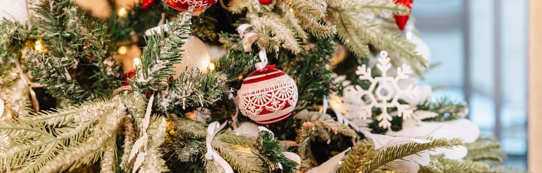 Christmas decorations on the branches fir,Decorated Christmas tree on blurred, sparkling and fairy background