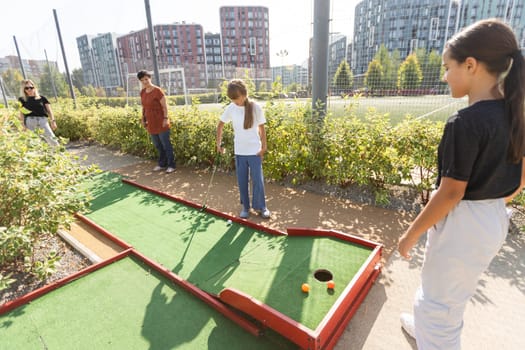 Kids playing golf inside playground artificial grass activity game for children . High quality photo