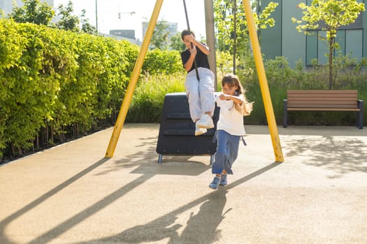 A young girl enjoys the pole ride at the playground runaway, on a warm day. High quality photo