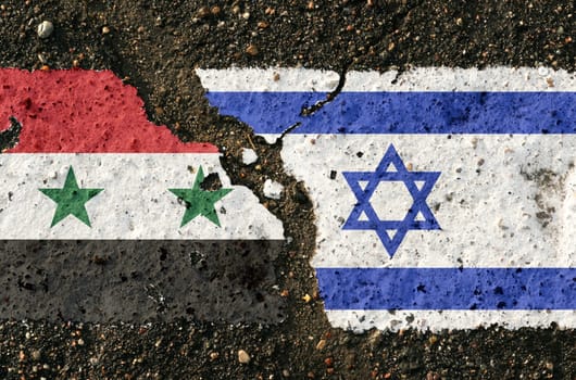 On the pavement are images of the flags of Israel and Syria, as a symbol of confrontation. Conceptual image.