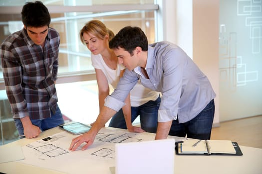 Team of architects working on construction plans