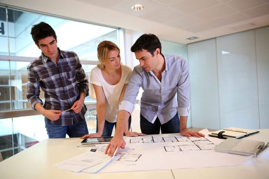 Team of architects working on construction plans