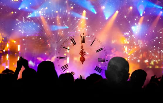 Clock close to midnight, fireworks and crowd waiting for New year