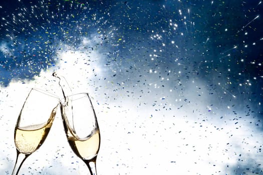 Glasses with champagne against fireworks and holiday lights