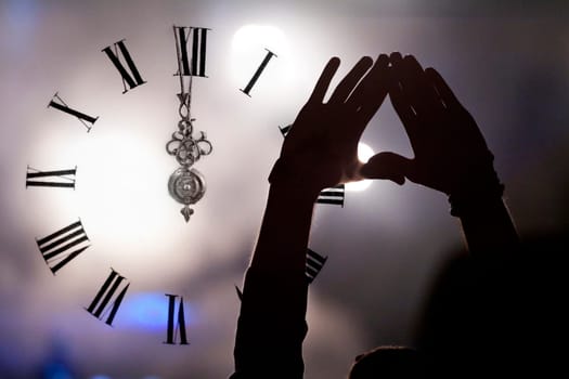 Clock close to midnight, fireworks and crowd waiting for New year