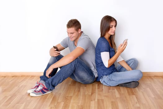 Young people sending messages with mobile phone