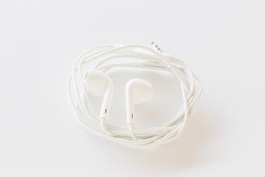 Smartphone ear buds isolated on white background, stock photo