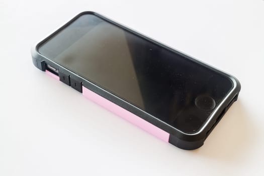 Black smartphone in protection case isolated on white background, stock photo