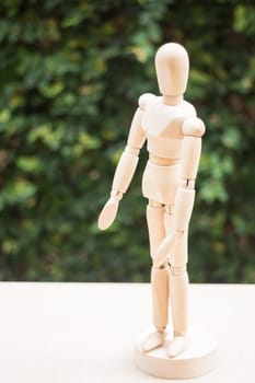 Wooden artist manikin pose on the table, stock photo