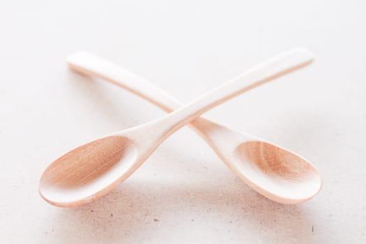 Empty spoons on brown background, stock photo