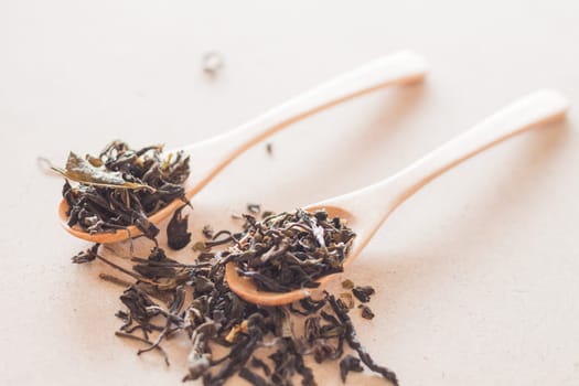 Dry tea in wooden spoons, stock photo