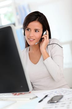 Woman in office having a video conference with business partners