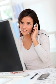 Woman in office having a video conference with business partners