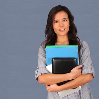 Student holding pile of files