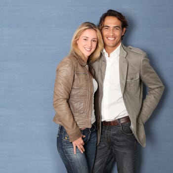 Couple standing on grey background