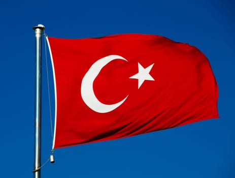 Turkish national flag over blue sky
