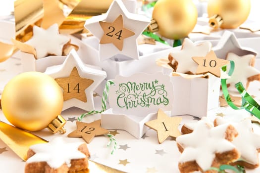 Advent calendar made of star-studded gift boxes with places,cinnamon stars