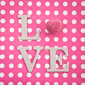 LOVE written with pink praline on pink background