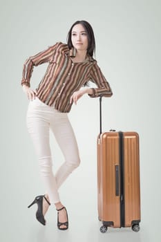 Modern Asian woman stand with a luggage.