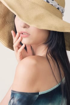 Glamour of Asian beauty with hat, closeup portrait.