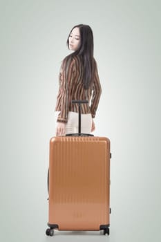 Modern Asian woman stand with a luggage.