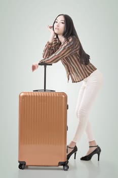 Modern Asian woman stand with a luggage.