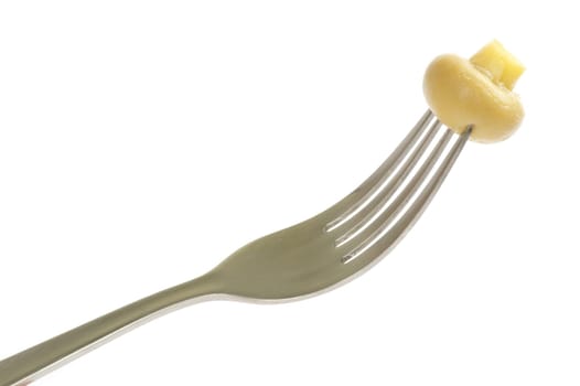 Fresh mushroom on a fork isolated on white background