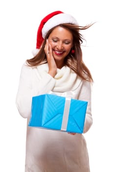 Young woman with brown hair and Christmas hat with a large turquoise colored gift isolated against white background