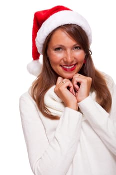 Attractive woman wears a festive red Christmas hat and cuddles up in a turtleneck sweater with a charming friendly smile,isolated on white