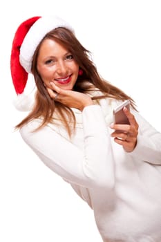 Attractive woman with red Santa hat reads a text message on her phone smartphone and sends Christmas wishes smiling with joy isolated on white with text-free free-space