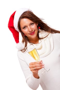 Attractive woman with red Santa hat holds a glass of champagne in her hand and smiles isolated on white background freeing text space