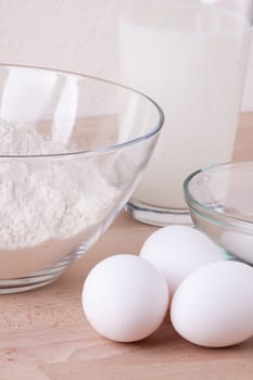 Baking ingredients in the kitchen me eggs,flour,butter and sugar to stir a dough and bake a cake