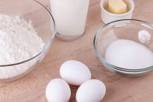 Baking ingredients in the kitchen me eggs,flour,butter and sugar to stir a dough and bake a cake