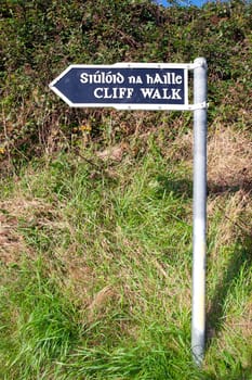 cliff walk sign beside the cliffs in Ballybunion county Kerry Ireland in English and Gaelic