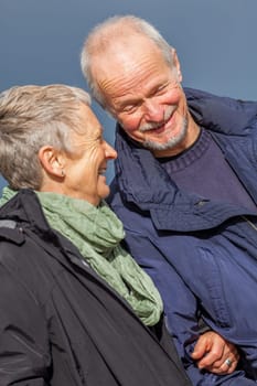 older adult happy couple walks on the beach in autumn lifestyle happiness