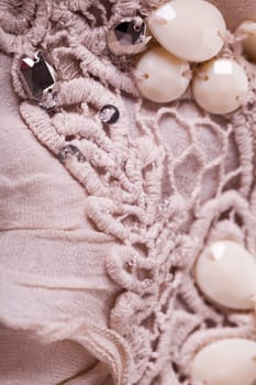 Embroidered fabric with stones of wool cotton Lienen structure texture as close-up background