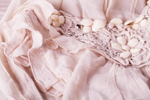 Embroidered fabric with stones of wool cotton Lienen structure texture as close-up background