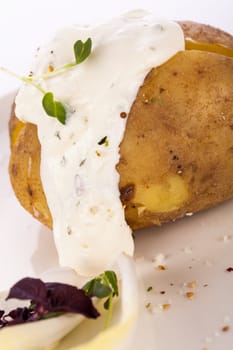 fresh foilpotato from the oven with herb quark sour cream and fresh herbs