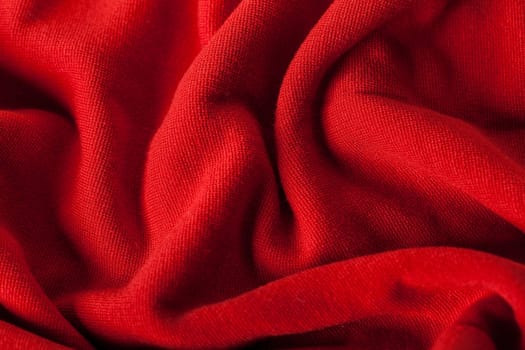 Structure of a red soft fabric as close-up texture