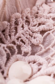 Embroidered fabric with stones of wool cotton Lienen structure texture as close-up background