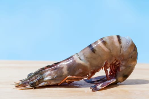 Fresh shrimp on a wooden board as a close-up