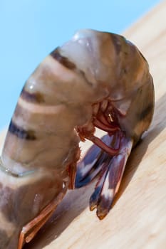 Fresh shrimp on a wooden board as a close-up