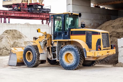 Shovel loader wheel loader with large shovel in the construction industry in the open air in daylight